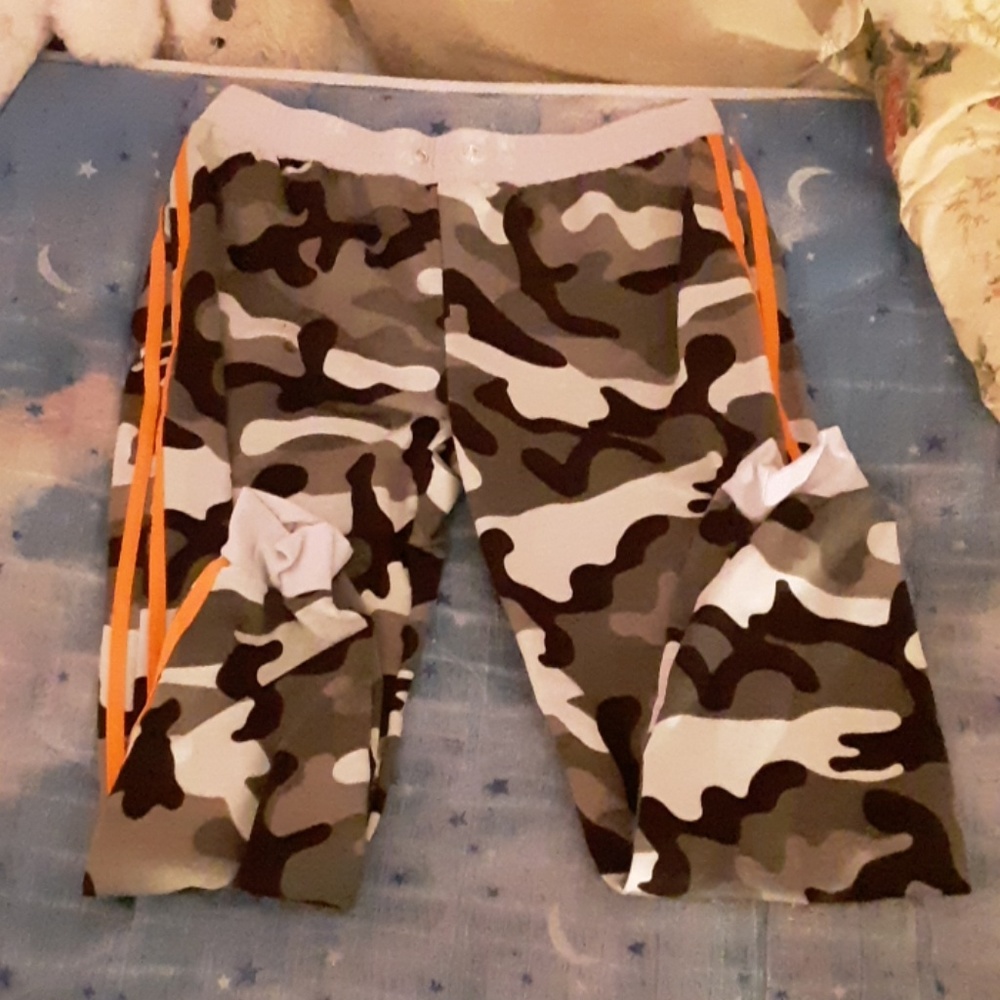 Camo with orange stripes on the sides.